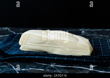 Turkish Cheese Abaza Peyniri on Black Tablecloth. Traditional Organic Food. Stock Photo