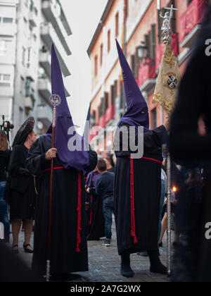 Granada, Spain - April 16, 2019. Two of many Nazarenos that participate in the processions of catholic brotherhoods that carries out during Easter in Stock Photo