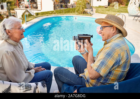 Happy senior couple spending time together and captures with a camera at holiday Stock Photo