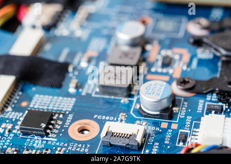 Electronic components, chips and capacitors on the blue pcb, close up view. Technology concept Stock Photo
