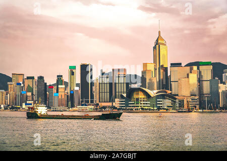 Dry cargo vessel at Victoria Harbor in Hong Kong sunset Stock Photo