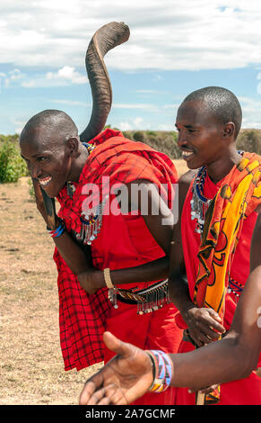 MASAI MARA, KENYA - MAY 2014: Masai warriors welcoming the tourist traditional as cultural ceremony near to Masai Mara National Park Stock Photo