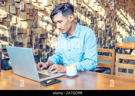 Young Asian businessman working on a laptop Stock Photo