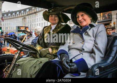 Regent Street, London, UK, 02nd Nov 2019. Two ladies in Victorian outfits in a classic car, part of the Concours d’Elegance of veteran cars, with over 100 pre-1905 motors. London's Regent Street is pedestrianised for the day to host the annual Route 66 Regent Street Motor Show, featuring a full spectrum of beautiful cars on display to the public, from classic motors to famous supercars, Ultra Low electric vehicles and iconic Route 66 Americana automobiles. Credit: Imageplotter/Alamy Live News Stock Photo