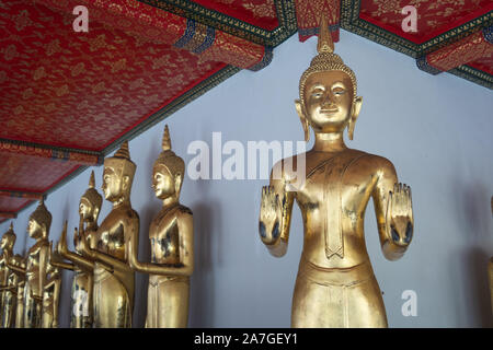 Buddha images in a row at Wat Pho, also known as Wat Phra Chetuphon, 'Wat' means temple in Thai. The temple is one of Bangkok's most famous tourist Stock Photo