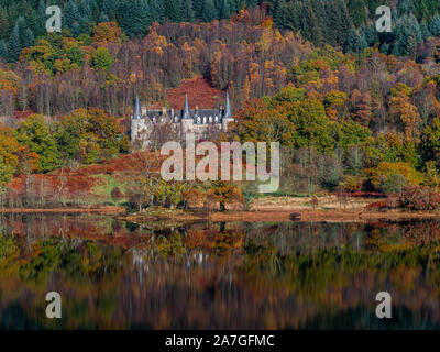 Colourful autumn reflections on a calm Loch Achray in the Trossachs National Park in the Scottish highlands Stock Photo