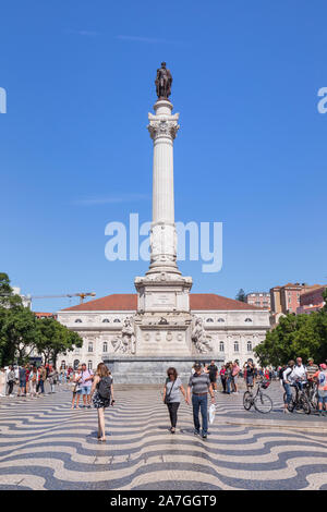 Tourists and Column and statue of Dom Pedro IV at the Rossio Square (Praca do Rossio) in the Baixa district in Lisbon, Portugal, on a sunny day. Stock Photo