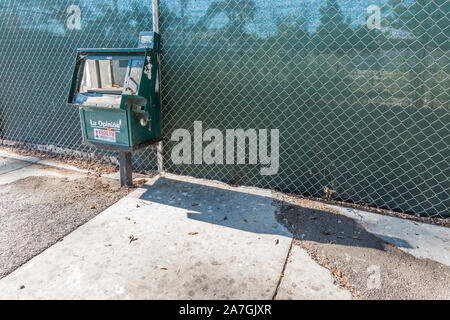 Abandoned coin-operated newspaper machine in poor condition. Stock Photo