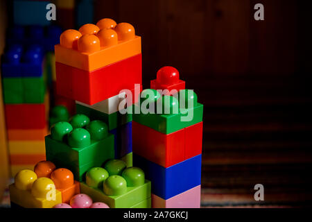 Lot of colorful rainbow toy bricks background. Educational toy for children Isolated on white background. Top view with copy space Stock Photo