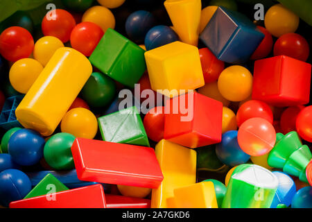 Multicolored plastic building blocks of the designer. Background of plastic colored details building blocks. Parts of bright small spare parts for toy Stock Photo