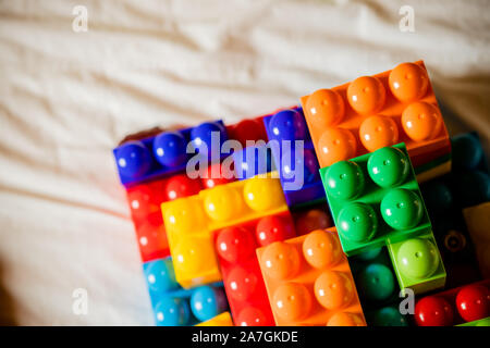 Lot of colorful rainbow toy bricks background. Educational toy for children Isolated on white background. Top view with copy space Stock Photo