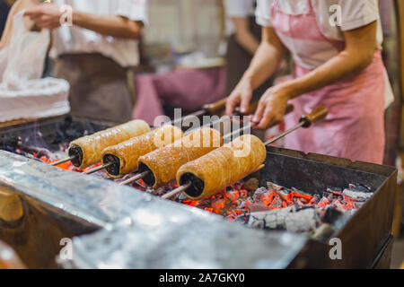 Preparation of the famous, traditional and delicious Hungarian Chimney Cake Stock Photo