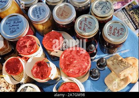 Various kinds of food, including canned items, freely exchanged at a community food swap held in the backyard of a participant's home, Wisconsin, USA Stock Photo