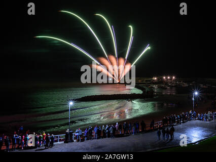 Lyme Regis, Dorset, UK.  2nd November 2019. UK Weather: After a day of torrential downpours the rain clears for a short time at Lyme Regis.  Visitors and locals gather to enjoy a spectacular annual firework display to celebrate bonfire night.  Credit: Celia McMahon/Alamy Live News. Stock Photo