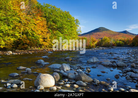 Autumn foliage on Big Coolidge Mountain from along the East Branch of the Pemigewasset River in Lincoln, New Hampshire on an autumn morning. This moun Stock Photo