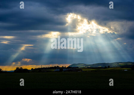 Rays of sun in the evening sky in Scotland Stock Photo