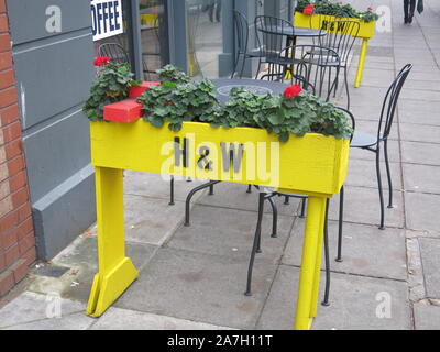 The iconic yellow cranes of Harland & Wolff that dominate the Belfast skyline are used as the inspiration for these flower planters in the city centre. Stock Photo