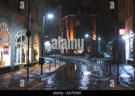 Snowy empty street at night in Aachen, Germany Stock Photo