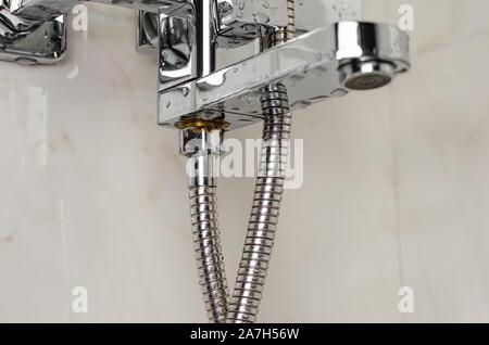 Close up of rusted nut on a new water tap in shower. Copy space Stock Photo