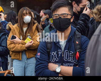 London, UK. 2nd November 2019. Protesters almost all dressed in black and many with black masks meet at Marble Arch to march along the pavement of Oxford St calling for Hong Kong to be free and making five demands. They want complete withdrawal of the Extradition Bill, a retraction of characterising the protests as riots, withdrawal of prosecutions against protesters, an independent investigation into police brutality and the implementation of Dual Universal Suffrage.Peter Marshall/Alamy Live News Stock Photo