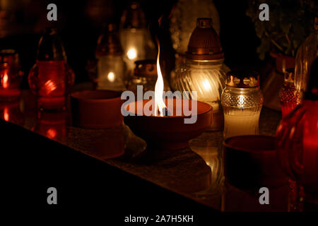 Candle burning at a Cemetery during All Saints Day close up Stock Photo
