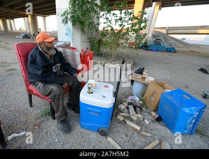 Days before a threatened crackdown by Texas Governor Greg Abbott on public right-of-way camping, a homeless Texan awaits  the governor's and highway department actions in Austin. Most are unsure where they will go as local shelters are over capacity. Stock Photo