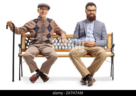 Full length portrait of an elderly man sitting on a bench next to his son isolated on white background Stock Photo