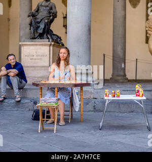 Pisa, Italy - August 28, 2018: Street musician female performs on Pisa street during summer time Stock Photo