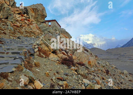 View of Mount Everest from the RongPu Monastery, at the Everest Base Camp in Tibet, against a blue sky. Stock Photo