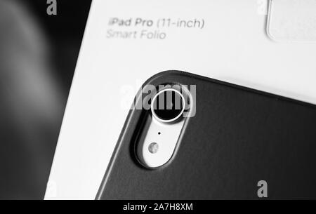 Paris, France - Feb 12, 2019: macro close-up shot of rear camera photo lens of new iPad Pro tablet with protective Smart Folio by Apple Computers - bl Stock Photo