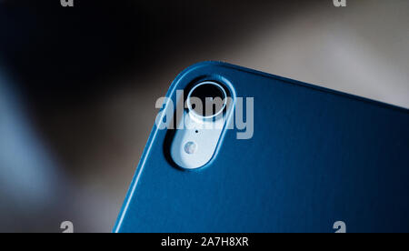 Paris, France - Feb 12, 2019: macro close-up shot of rear camera photo lens of new iPad Pro tablet with protective Smart Folio by Apple Computers blue Stock Photo