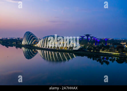 Early morning aerial panorama of Cloud Dome and Flower Dome with Supertree grove reflected in Marina Bay Singapore Stock Photo