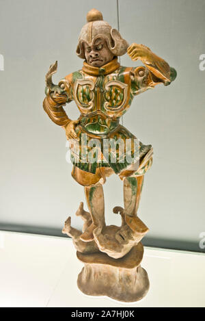 Chinese porcelain: Polychrome glazed pottery statue of Heavenly Guardian. Tang Dynasty (618-907 A.D.). Shanghai Museum, China. Stock Photo