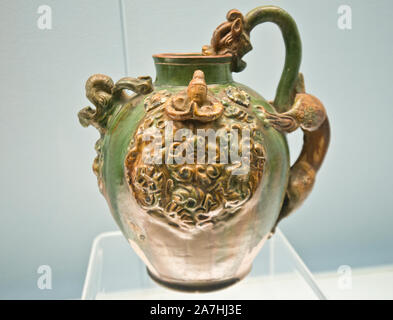 Chinese porcelain: Polychrome glazed pottery pitcher with dragon head and applied design. Tang Dynasty (618-907 A.D.). Shanghai Museum, China. Stock Photo