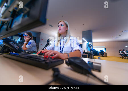 Female security operator working in a security  data control room offices Stock Photo