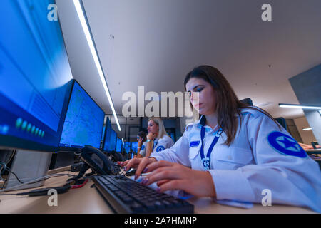 Female security operator working in a security  data control room offices Stock Photo