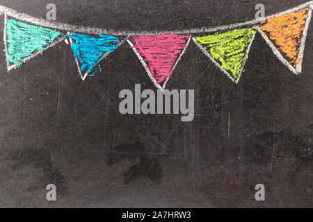 Colorful chalk drawing in hanging party flag shape on blackboard background Stock Photo