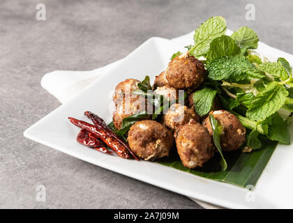 Spicy deep fried pork larb , Laab Moo Tod , Thai style recipe Stock Photo