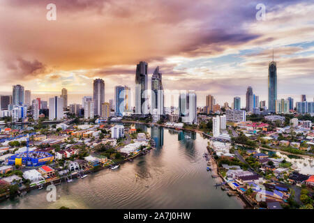 High-rise towers of hotels and residential apartments on waterfront of SUrfers Paradise city of AUstralian Gold Coast facing rising sun over Pacific o Stock Photo