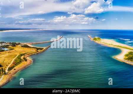 Delta of Hunter Valley entering pacific ocean off Newcastle city along distant Stockton beach between capes and breakwater walls forming path for carg Stock Photo