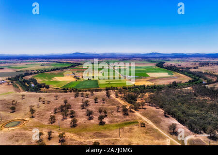 Hunter river looping around flat plains in Hunter Valley providing water and irrigation to agriculture farm. Aerial view of river bend on wide arid pl Stock Photo