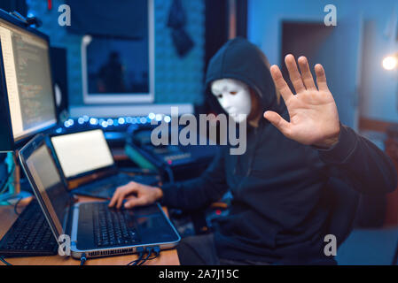 Hacker in mask and hood, account hacking Stock Photo