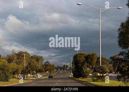Suburban Australian multiple lane highway with storm on the horizon. Stock Photo