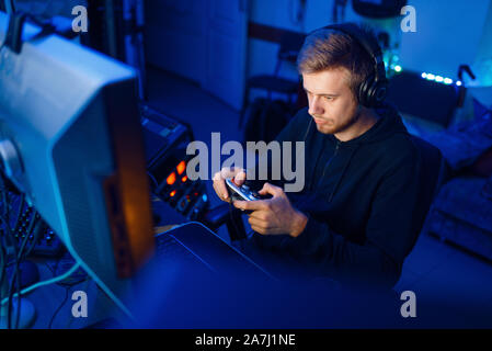 Gamer with joystick playing videogame on console Stock Photo