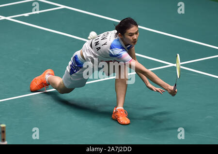 Han Yue of China returns a shot to Sayaka Takahashi of Japan during the