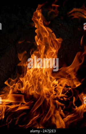 Fire flames on dark background of a natural wood fire Stock Photo