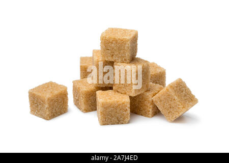 Heap of cane sugar cubes close up isolated on white background Stock Photo