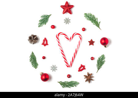 Christmas composition. Christmas wreath made of fir tree branches, decorations, berries with candy heart on white background. Christmas, winter, new y Stock Photo