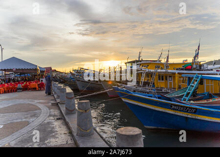 seaside view of a fish market with boats lining up Stock Photo