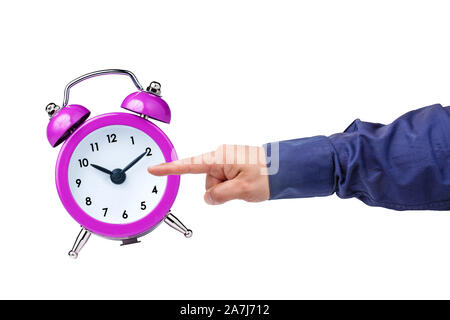 Hand pointing at vintage colorful clock alarm isolated on white Stock Photo